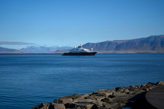 Superyacht Anchored in Calm Blue Bay with Volcanic Mountains, Reykjavik, Iceland