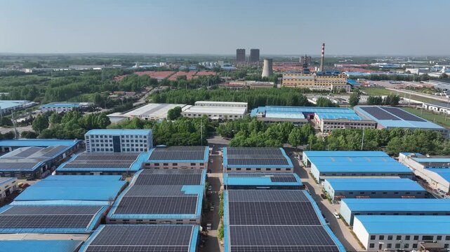 Aerial view of distributed photovoltaic arrays installed on industrial park rooftops