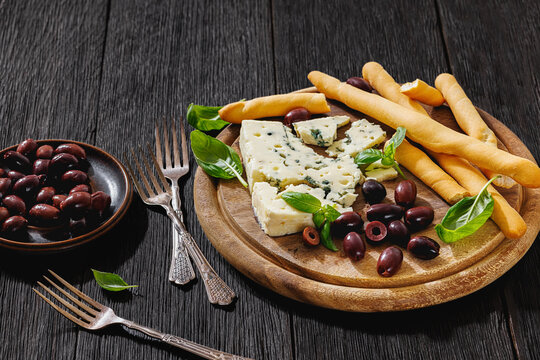 Premium blue cheese board with grissini and olives