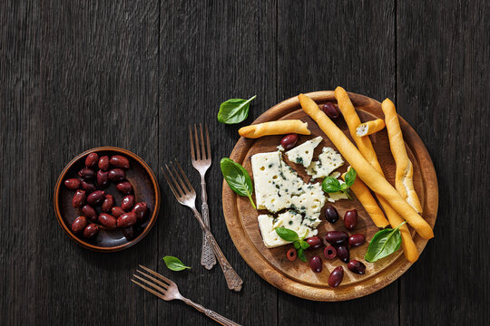 Premium blue cheese board with grissini and olives