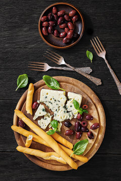 Premium blue cheese board with grissini and olives
