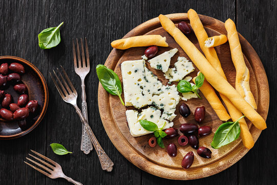 Premium blue cheese board with grissini and olives