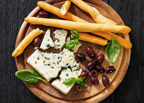 Premium blue cheese board with grissini and olives