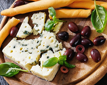 Premium blue cheese board with grissini and olives