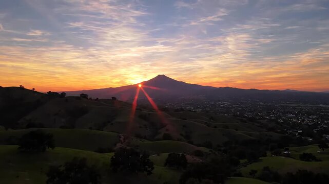 Cinematic drone shot of Mt Diablo at sunset overlooking the rolling green landscape of Dougherty Hills in San Ramon California