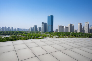 Rizhao city skyline with green belt and modern high-rise buildings under clear blue sky © zhu difeng