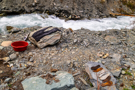 Outdoor Laundry Preparation by Fast-Flowing Mountain River