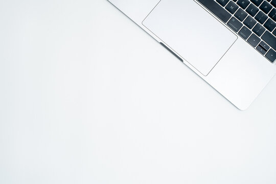 Top View of Modern Laptop Keyboard and Trackpad on White Background with Copy Space