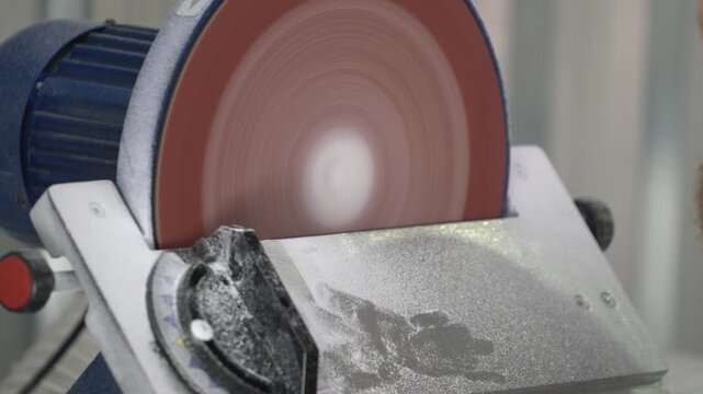 Industrial Grinding Wheel Polishing Stone Surface with High-Speed Abrasive Disc in Manufacturing Workshop