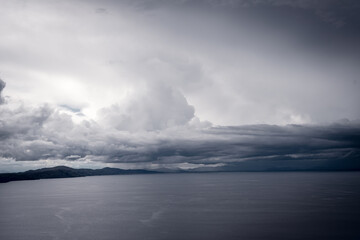 Fototapeta premium View of Lake Titicaca from Amantani Island under stormy clouds