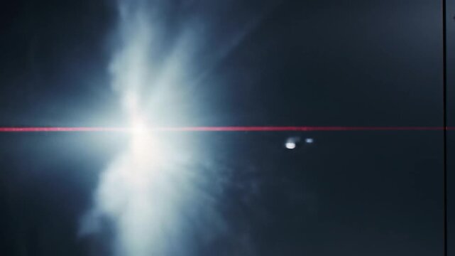 Close-up of a red laser beam scanning an access card reader on a dark door handle
