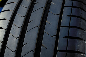Modern car tire tread close up black rubber automobile tyre protector pattern texture vehicle safety and maintenance concept © kalyanby