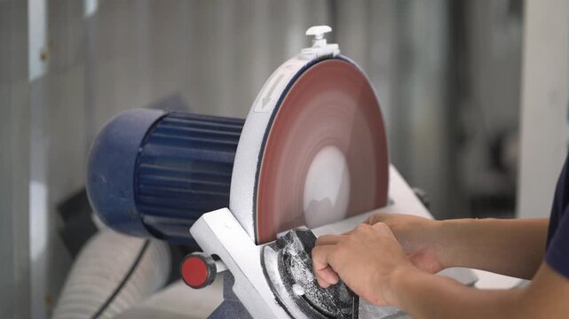 Industrial Grinding Wheel Polishing Stone Surface with High-Speed Abrasive Disc in Manufacturing Workshop