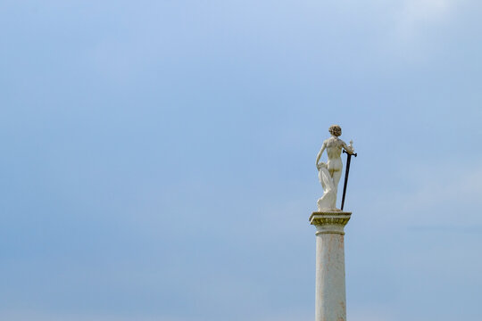 Statue on Column Against Blue Sky