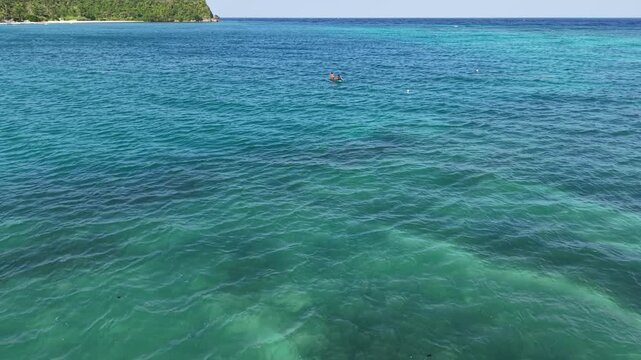 Aerial Over Tropical Sea Toward Lighthouse Headland, Siquijor Philippines, 4K

D: Aerial drone view low over teal tropical sea toward a jungle headland with a lighthouse near Lazi, Siquijor.