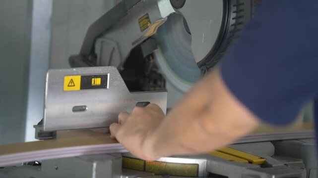 Worker measuring aluminum profile with tape measure at workshop machine