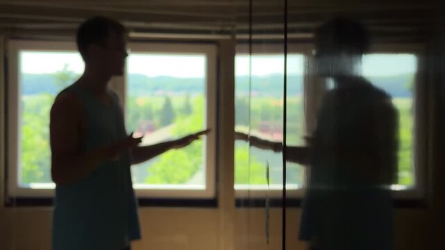Depressed teenager in a dark room trying to argue with his own reflection. Dissociative identity disorder