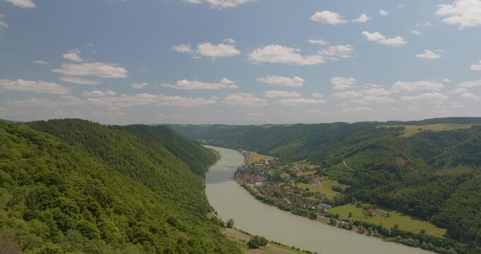 Beeindruckende Luftaufnahme der Donau sanften H&uuml;geln in Bayern. Panorama einer malerischen Flusslandschaft an einem sonnigen Sommertag.