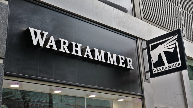 Manchester, England, UK - 18 June 2026: Warhammer store exterior, black shop front fascia and hanging logo sign of famous hobby and tabletop gaming franchise