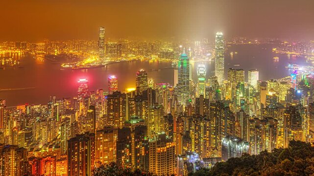 Hong Kong night panorama wide view of Victoria Harbour skyline from Victoria Peak. The Peak is the highest mountain in Hong Kong Island of China.