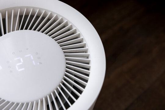 Close-up of details of a white, futuristic, and minimalist room humidifier.
