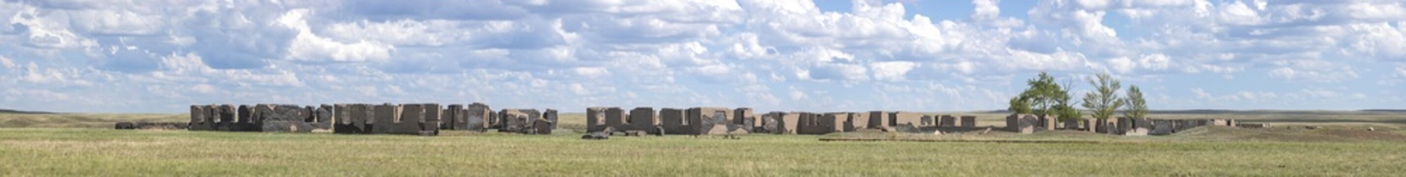 A panoramic view of the ruins of old structures in the steppes of Kazakhstan.
