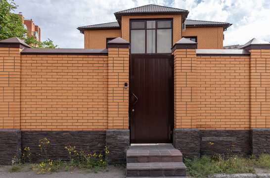 brick fence with a gate for entry into a private, enclosed area
