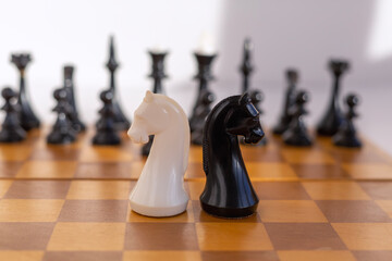Chess Knights Confrontation on Wooden Board © Александр Ланевский