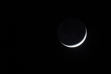 Wąski, lśniący sierp Księżyca z wyraźnie widocznym zjawiskiem światła popielatego, sfotografowany na tle nieskazitelnie czarnego, nocnego nieba nad Parkiem Narodowym Doliny Śmierci w Kalifornii. © Grzegorz