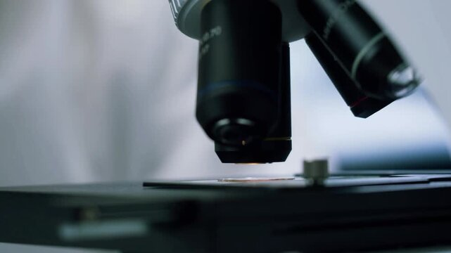 Male Research Scientist Using Microscope in Advanced Laboratory