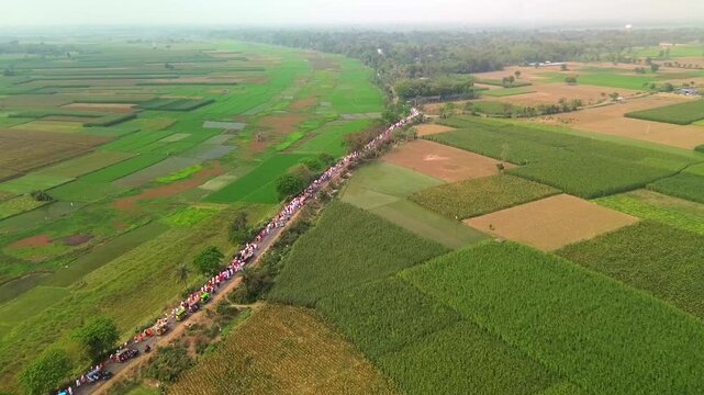 Pilgrims moving through farmers' fields in Mayapur. Drone footage taken at an altitude of approximately 60 meters.