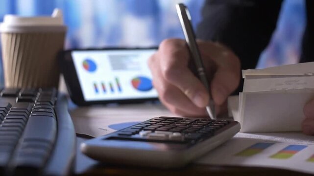 Business Professional Calculating Tax Return With Receipts At Office Desk