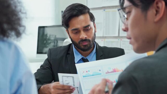 Diverse multiracial business team using AI bot to analyze restructuring strategy for profit growth in modern open office with screens and documents, corporate transformation planning concept