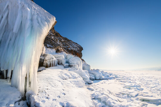 Ogoy island on winter Baikal lake with ice on the rocks. Baikal, Siberia, Russia.