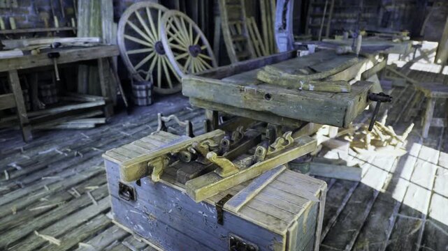 Wheelwright bench with stacked wagon wheels and wooden spokes, daylight highlighting hub and rim, workshop scene evoking restoration craft and traditional