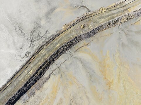 Causeway at a waste pond in the mineral-rich area of the Rio Tinto mines. Aerial view. Drone shot. Huelva province, Andalusia, Spain