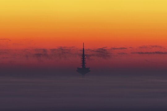 The Europaturm in Frankfurt am Main rises out of the fog and cloud cover over the Rhine-Main region at sunrise. Kronberg, Malerblick, Hesse, Germany