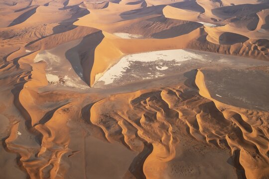 Sand dunes and dry pans in the Namib Desert. In the evening. Aerial view. Namib-Naukluft Park, Namibia