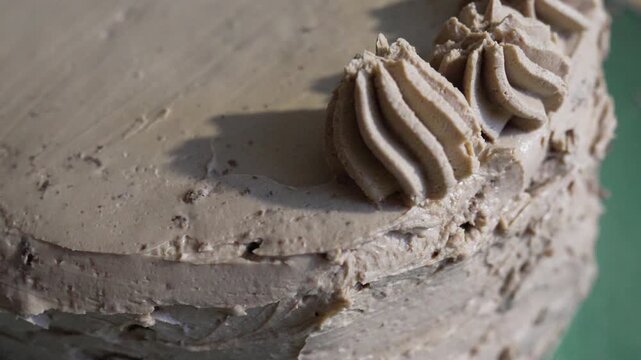 Cake decorating frosting, hands piping chocolate cream swirls onto a layer cake to create a beautiful dessert for celebration and birthday events