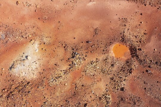 Little pool and extremely mineral-rich ground in the area of the Rio Tinto mines, the colour is caused by oxidised iron minerals, aerial view, drone shot, Huelva province, Andalusia, Spain