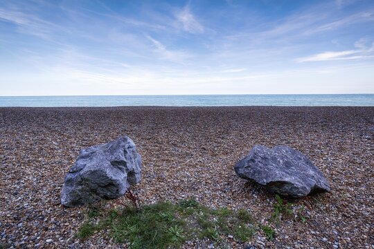 Two boulders on an empty shingle beach, Kingsdown Beach in the evening, Cirrus, Dover, Kent, England, Great Britain