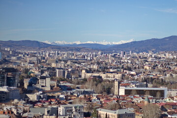 Naklejka premium A beautiful view of the city from the mountain. Tbilisi on a sunny day.