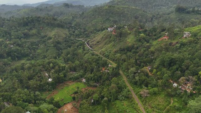 Train Approaching Through Lush Green Mountains in Ella, Sri Lanka &ndash; Aerial Drone View | Suitable for a documentary