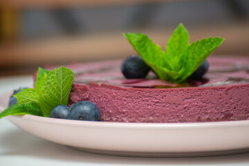 Mint leaf crowns a purple dessert © Q77photo