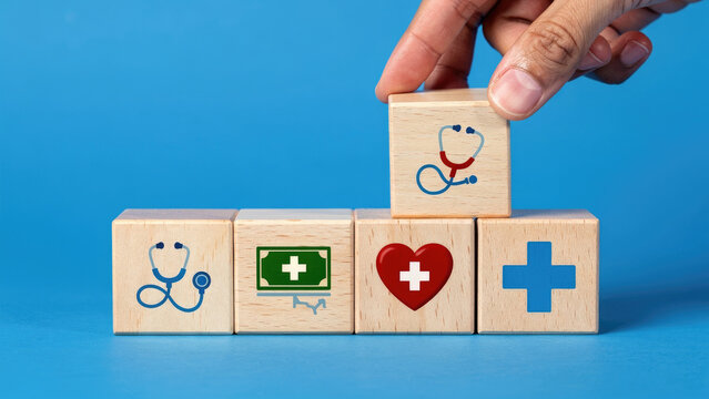 Hand placing a wooden block with a stethoscope icon on top of medical concept cubes.