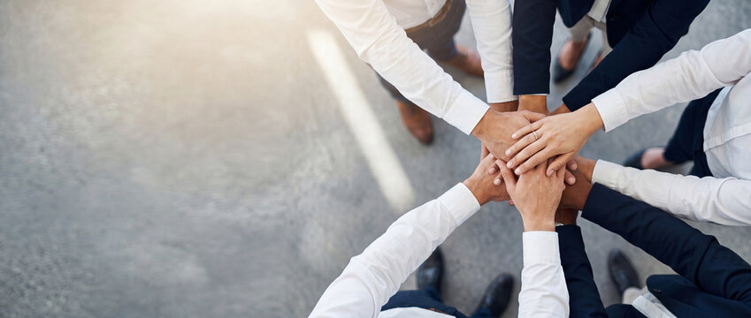 Business team stacking hands in a modern office