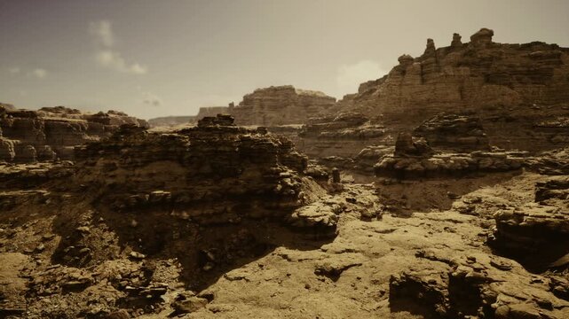 Sunlit rocky canyon panorama geologist surveying exposed strata, warm sepia light, rugged sandstone ledges, deep crevices, layered sediment textures, pale sky