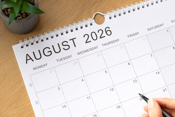 August 2026 calendar month on a wooden background. Top view. © Marinela