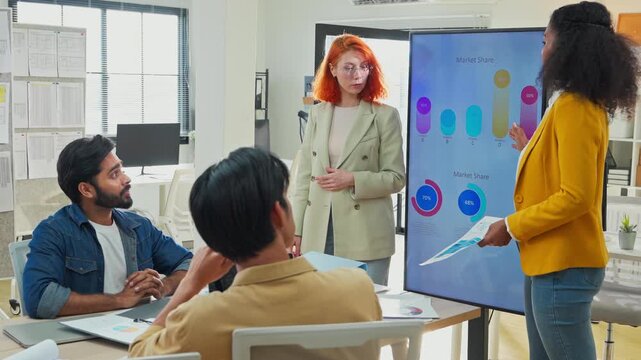 Diverse multiracial business team brainstorming in open modern office using AI bot to analyze and summarize client data, focused analysts presenting strategic plan, future of work concept