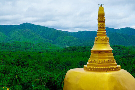 Golden pagoda at Wat Huai Nam Sai with mountain landscape in Suan Phueng, Ratchaburi, Thailand